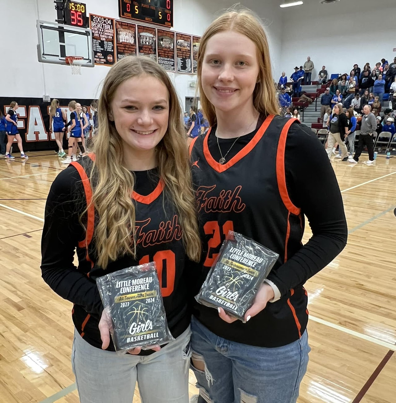 Two players holding their awards